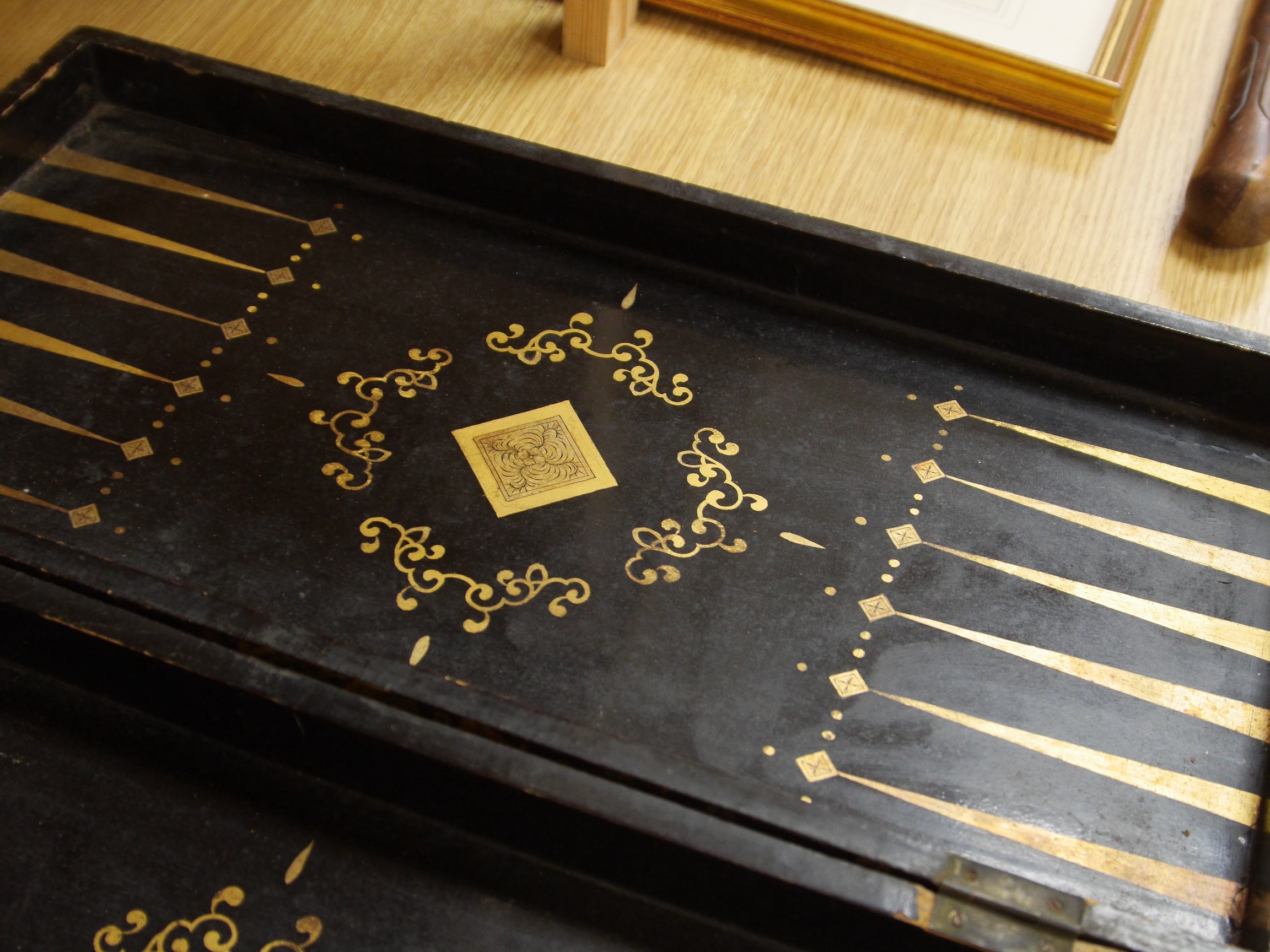 A late 19th/early 20th century Chinese lacquer chess board/box and a brass and mother of pearl mounted coromandel dome topped caddy, largest 49cm. Condition - fair